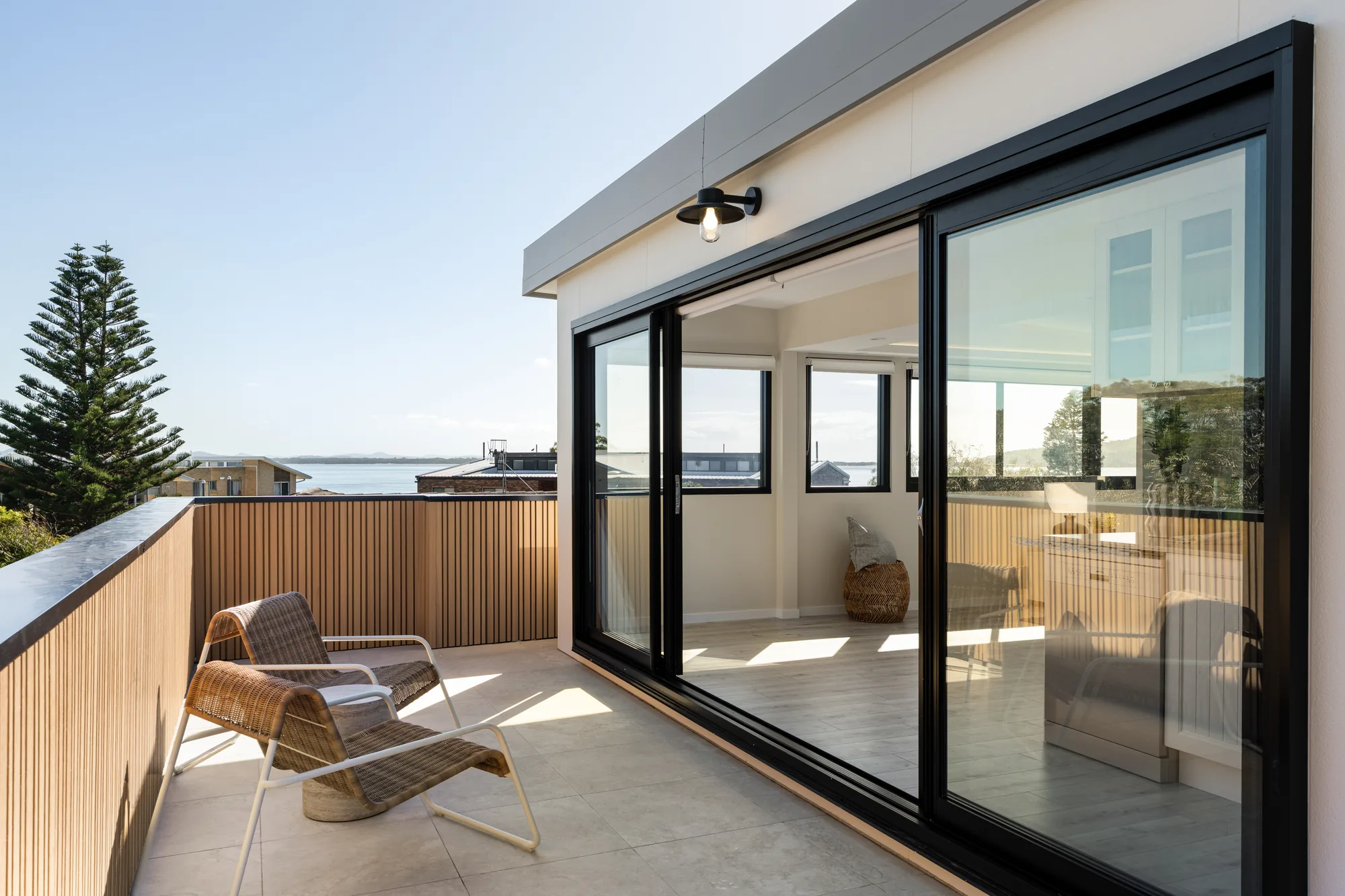 Nelson Bay Penthouse balcony with ocean views and black sliding glass doors
